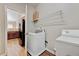 Convenient laundry room with a washer, dryer, and overhead shelving for storage at 1123 Claret Ln, Morrisville, NC 27560
