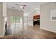 Open-concept living room boasts hardwood floors, fireplace, outdoor balcony, and a view into the kitchen at 1123 Claret Ln, Morrisville, NC 27560