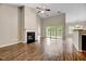 Spacious living room features a fireplace, hardwood floors, and slider access to the outdoor balcony at 1123 Claret Ln, Morrisville, NC 27560
