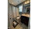 Full bathroom with shower-tub combo, single sink vanity, and dark blue walls at 116 Polenta Fields Dr, Smithfield, NC 27577