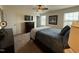 Bright primary bedroom with dark furniture, ceiling fan and lots of natural light at 116 Polenta Fields Dr, Smithfield, NC 27577