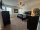 Bright primary bedroom with dark furniture, ceiling fan and lots of natural light at 116 Polenta Fields Dr, Smithfield, NC 27577