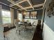 Elegant dining room with decorative ceiling, modern light fixture, and a round table set for a meal at 116 Polenta Fields Dr, Smithfield, NC 27577