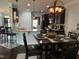 Open dining room with dark wood cabinets, dining table, and breakfast bar at 116 Polenta Fields Dr, Smithfield, NC 27577