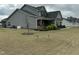Gray home with dark shutters, covered front porch and landscaping at 116 Polenta Fields Dr, Smithfield, NC 27577