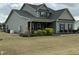 Charming two-story home with gray siding, covered porch, and manicured front lawn at 116 Polenta Fields Dr, Smithfield, NC 27577