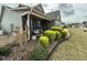 Cozy covered front porch with stone supports and a rocking chair at 116 Polenta Fields Dr, Smithfield, NC 27577