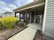 Cozy covered front porch with stone supports and a decorative wreath on the door at 116 Polenta Fields Dr, Smithfield, NC 27577