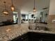 Open concept kitchen with granite countertops, breakfast bar, and view into living room at 116 Polenta Fields Dr, Smithfield, NC 27577