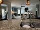 Open concept kitchen with granite countertops, breakfast bar, and view into living room at 116 Polenta Fields Dr, Smithfield, NC 27577