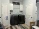 Functional laundry room includes modern washer and dryer with storage at 116 Polenta Fields Dr, Smithfield, NC 27577