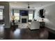 Bright living room featuring a fireplace, ceiling fan, hardwood floors, and white sofas at 116 Polenta Fields Dr, Smithfield, NC 27577