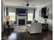 Bright living room featuring a fireplace, ceiling fan, hardwood floors, and white sofas at 116 Polenta Fields Dr, Smithfield, NC 27577