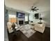 Bright living room featuring a fireplace, ceiling fan, hardwood floors, and white sofas at 116 Polenta Fields Dr, Smithfield, NC 27577