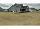 A spacious yard surrounds the gray home, offering ample space for outdoor activities at 116 Polenta Fields Dr, Smithfield, NC 27577
