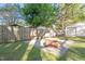 Backyard with a wooden fence, a fire pit, and a shed at 116 W Mciver St, Zebulon, NC 27597