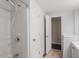 Bathroom with shower over tub and open doorway to vanity area at 116 W Mciver St, Zebulon, NC 27597