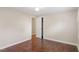 Bedroom featuring hardwood floors, neutral walls, and a closet with a white door at 116 W Mciver St, Zebulon, NC 27597