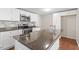 Modern kitchen with stainless steel appliances, granite countertops, and custom backsplash at 116 W Mciver St, Zebulon, NC 27597