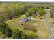 Stunning aerial view of a home surrounded by lush trees, offering privacy and tranquility at 1174 Robertson Rd, Roxboro, NC 27574