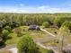 Expansive aerial view of a brick home nestled among lush trees and greenery on a large lot at 1174 Robertson Rd, Roxboro, NC 27574