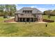 Brick home with a large wooden deck, ideal for entertaining and enjoying the beautiful outdoor space at 1174 Robertson Rd, Roxboro, NC 27574