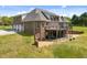 Brick home with a spacious wooden deck perfect for outdoor entertaining, offering views of the surrounding landscape at 1174 Robertson Rd, Roxboro, NC 27574