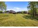 Expansive backyard with green grass surrounding a brick home with a deck, ideal for outdoor activities at 1174 Robertson Rd, Roxboro, NC 27574