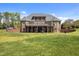 The rear of this beautiful brick home has a manicured lawn and mature trees providing privacy at 1174 Robertson Rd, Roxboro, NC 27574