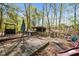 Outdoor entertaining space with mature trees, playground, bar and covered outdoor kitchen at 1174 Robertson Rd, Roxboro, NC 27574