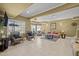 Open-concept basement with tile flooring, comfortable seating, and abundant lighting fixtures at 1174 Robertson Rd, Roxboro, NC 27574