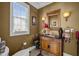 Classic-style powder room featuring dark wood vanity with black countertop and decorative accents at 1174 Robertson Rd, Roxboro, NC 27574