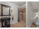 Bathroom showcasing a tiled shower, and a unique vanity with decorative mirror at 1174 Robertson Rd, Roxboro, NC 27574