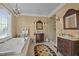 A well-appointed primary bathroom featuring dual vanities, soaking tub and a separate shower at 1174 Robertson Rd, Roxboro, NC 27574
