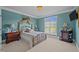 A charming bedroom with a decorative bed frame, soft lighting, and an ample window view at 1174 Robertson Rd, Roxboro, NC 27574