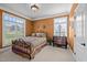 Cozy bedroom with patterned bedding, traditional wood furniture and lots of natural light at 1174 Robertson Rd, Roxboro, NC 27574