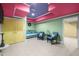 This bonus room features vibrant color, charming seating, and tile flooring at 1174 Robertson Rd, Roxboro, NC 27574