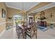 Formal dining room with chandelier, large windows, and elegant furnishings at 1174 Robertson Rd, Roxboro, NC 27574
