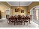 Elegant dining room featuring a chandelier, decorative trim, and large windows at 1174 Robertson Rd, Roxboro, NC 27574