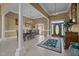 Elegant foyer featuring tiled floors, pillars, chandelier, and decorative rug at 1174 Robertson Rd, Roxboro, NC 27574