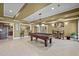 Basement game room with a pool table, bar area, and ample space for entertaining at 1174 Robertson Rd, Roxboro, NC 27574