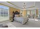 Spacious primary bedroom with a decorative headboard, a chandelier and a sitting area at 1174 Robertson Rd, Roxboro, NC 27574