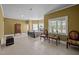 Spacious main bedroom with tile floors, decorative furniture, a large window, and a wrought iron bed frame at 1174 Robertson Rd, Roxboro, NC 27574