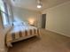 Bedroom featuring a full-sized bed, a ceiling fan, and ample natural light from the large window at 127 Long Shadow Pl, Durham, NC 27713