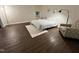 Bedroom featuring a full bed, decorative rug, and comfortable chair on a wood floor at 127 Long Shadow Pl, Durham, NC 27713
