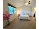 Bright bedroom featuring a vaulted ceiling, a comfortable bed, carpeted floors, and natural light at 127 Long Shadow Pl, Durham, NC 27713