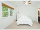 Bright bedroom featuring a ceiling fan and a large window that illuminates the space with natural light at 127 Long Shadow Pl, Durham, NC 27713