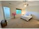 Airy bedroom offers a bright window, a ceiling fan, and an adjacent bathroom with walk-in closet at 127 Long Shadow Pl, Durham, NC 27713
