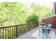 Spacious wooden deck with a cozy seating area surrounded by mature trees at 127 Long Shadow Pl, Durham, NC 27713