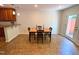 Cozy dining area features a wood table with four chairs and easy access to the kitchen and the backyard at 127 Long Shadow Pl, Durham, NC 27713